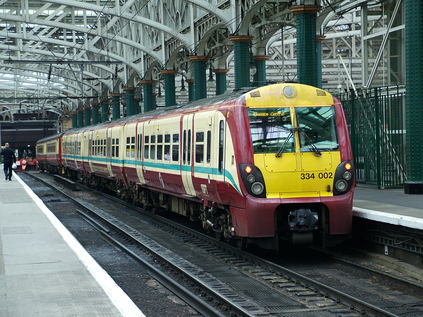 334002 under the impressive roof at Glasgow Central