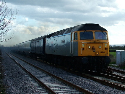 In a now defunct livery itself, 47828 leads former Midland Mainline liveried stock set LA79 through Highbridge