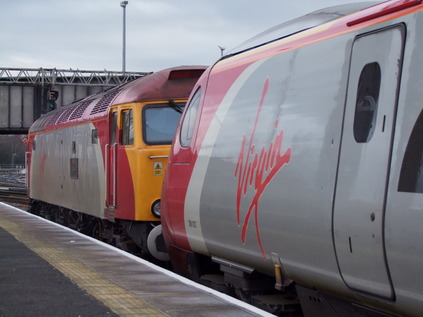 57311 waits to leave Chester with 390027 for Holyhead