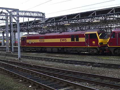 EWS liveried 92031 leads a short convoy