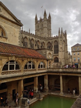 Bath Abbey looms over the Roman Baths