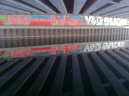 Graffiti reflected in the surface of the Hertford Union Canal